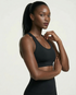 Active Comfort Sports Bra in black with racerback design, breathable stretch fabric, and discreet back pocket for active support and comfort