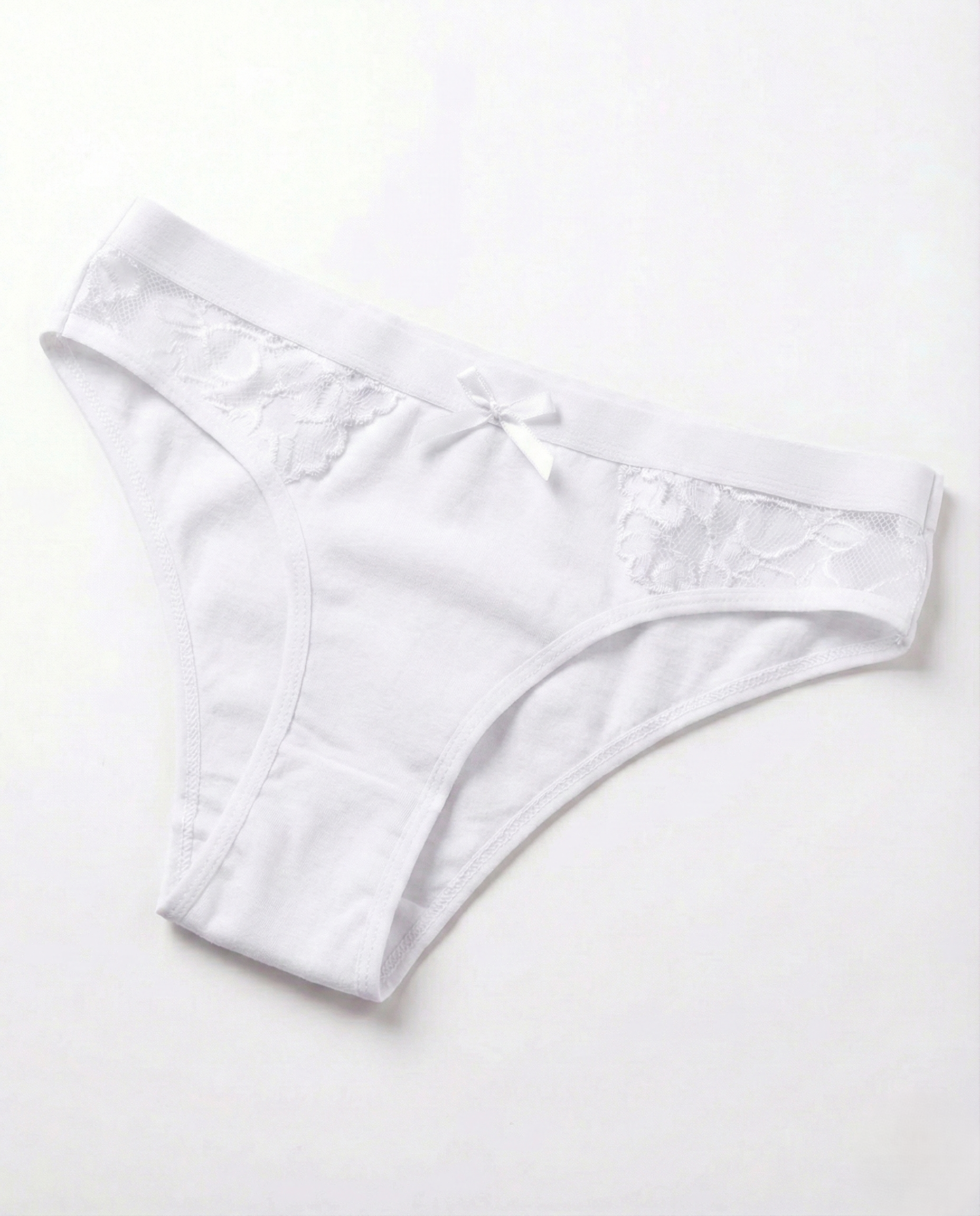 Close-up of low-rise cotton sexy panties with lace trim and mini bow, made from soft stretch cotton blend for natural comfort and flattering fit