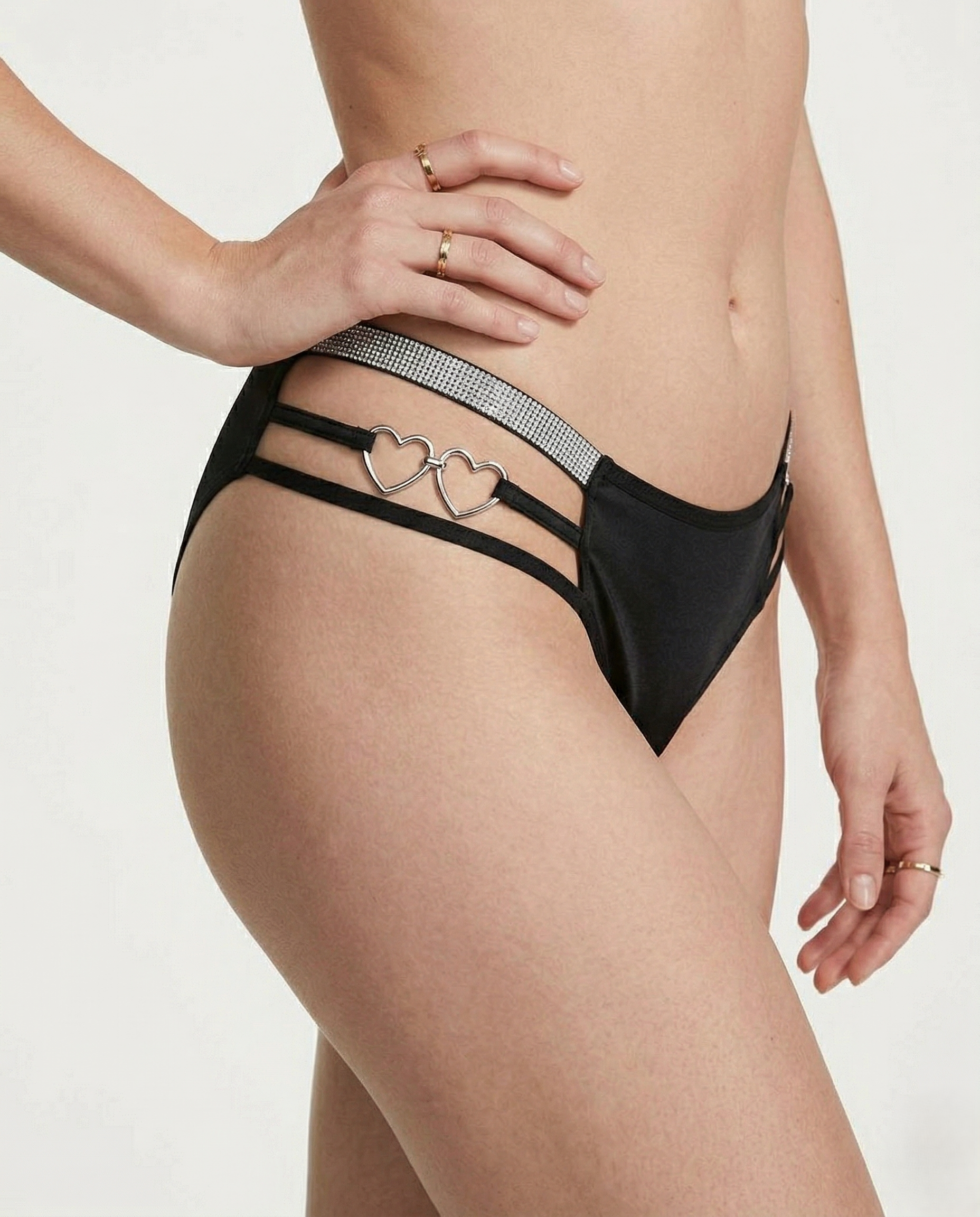Heart-shaped plus size thong with romantic embroidery and mid-rise fit on a mannequin