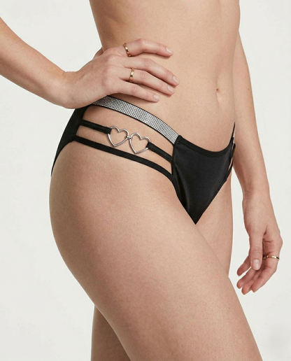 Heart-shaped plus size thong with romantic embroidery and mid-rise fit on a mannequin