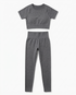 Woman wearing seamless fitness set with short-sleeve top and stretch pants in vibrant color