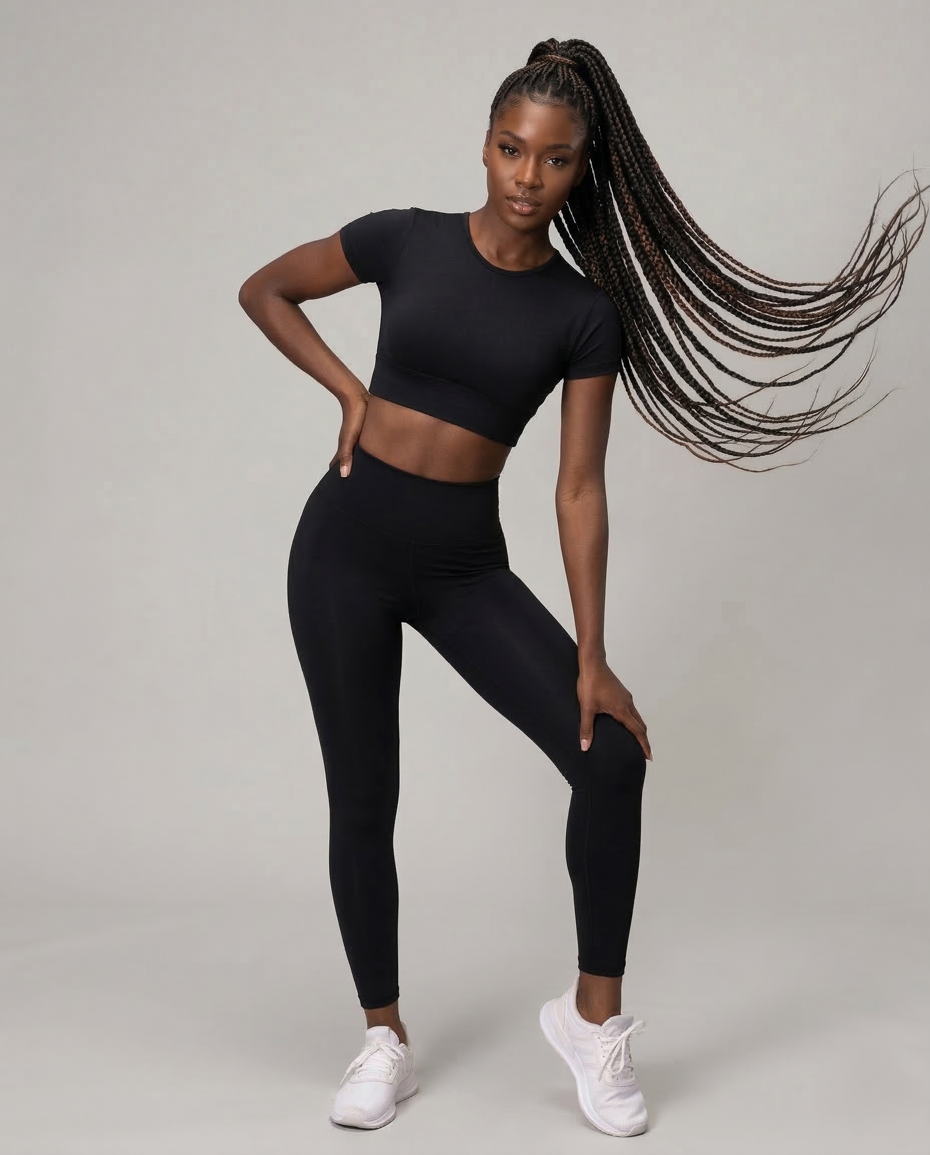Woman wearing seamless fitness set in vibrant color, featuring short-sleeve top and stretch performance pants for workout comfort