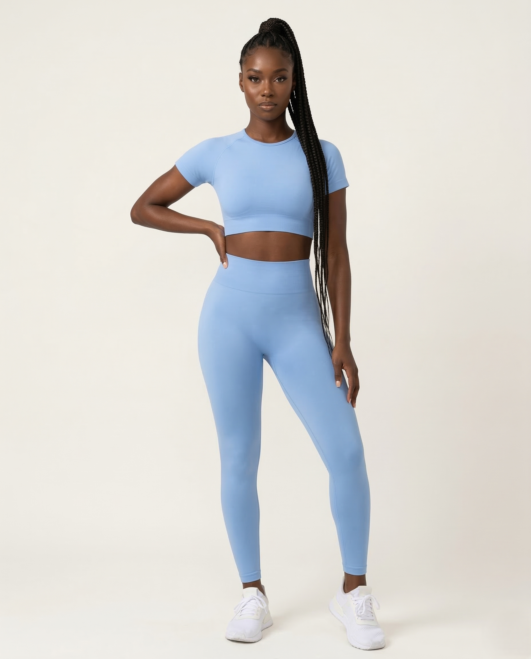 Woman wearing seamless fitness set with short sleeve top and stretch pants in vibrant color