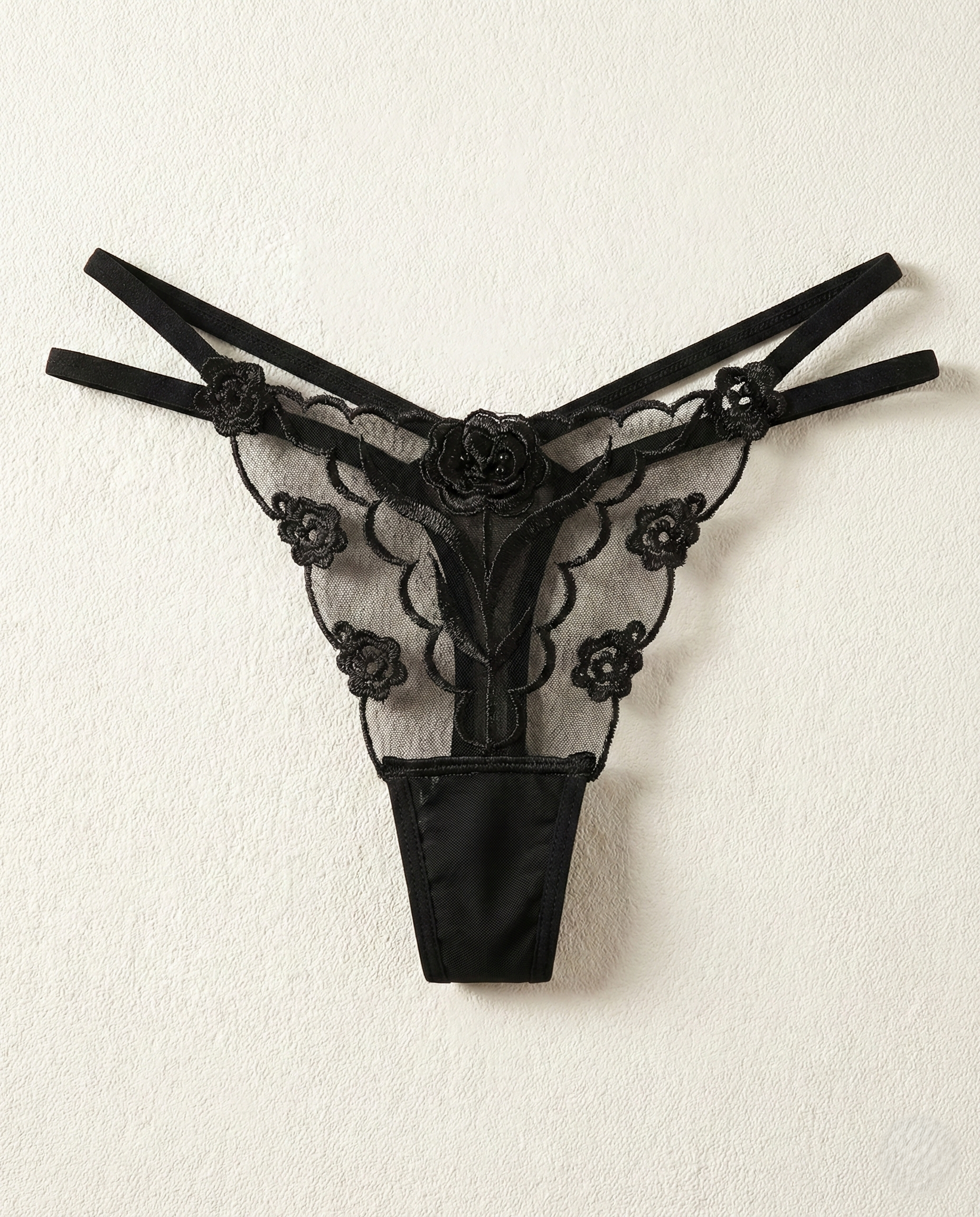 Sheer lace embroidered thong with delicate mesh and animal-inspired embroidery enhancing natural curves