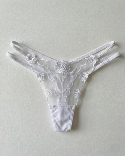 Sheer lace embroidered thong with delicate floral animal-inspired patterns and sheer mesh fabric enhancing curves
