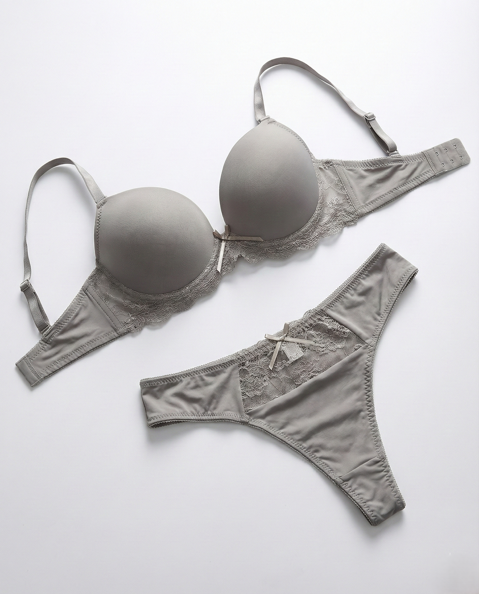 Woman wearing silky seamless lingerie set with floral lace and bow accents, smooth fit and underwire support